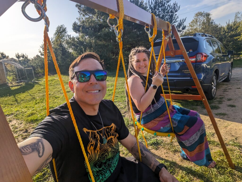 married couple sitting on a swing set